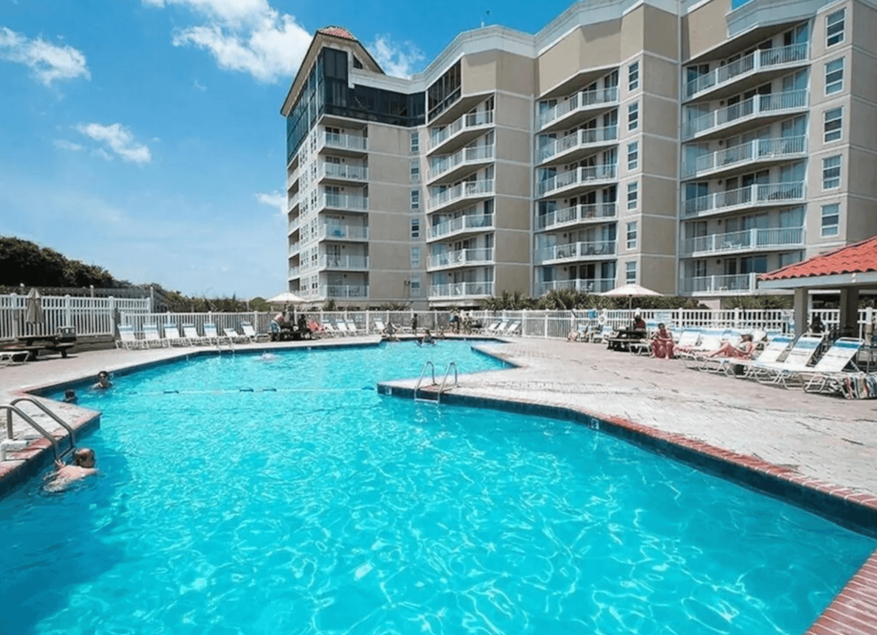 The oceanfront outdoor pool at St. Regis Resort with the condo tower behind, North Topsail Beach