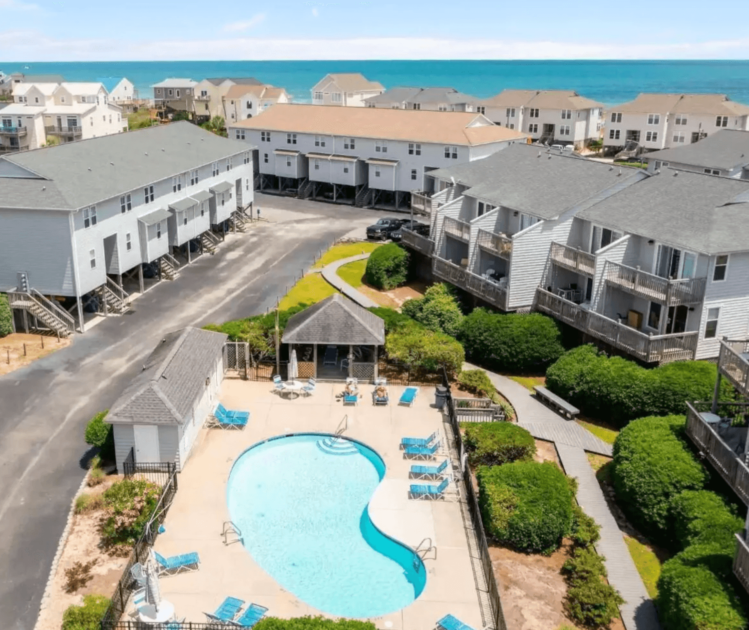 Aerial view of the Turtle Cove townhouse community in Surf City, with the shared pool and the Atlantic beyond