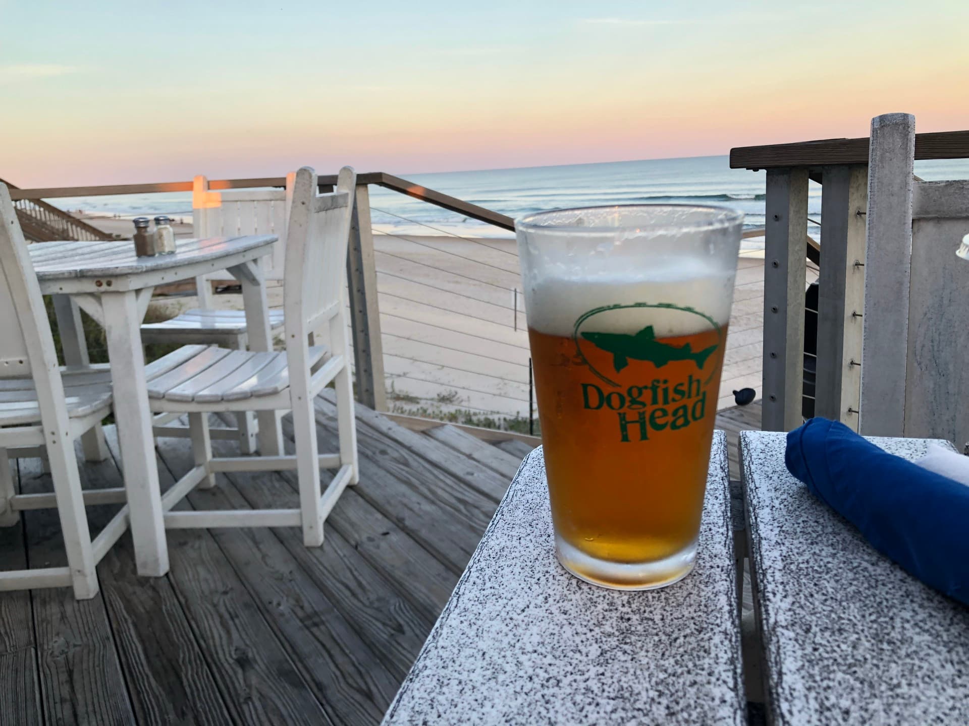 Cold beer on the oceanfront patio at Daddy Mac's at sunset